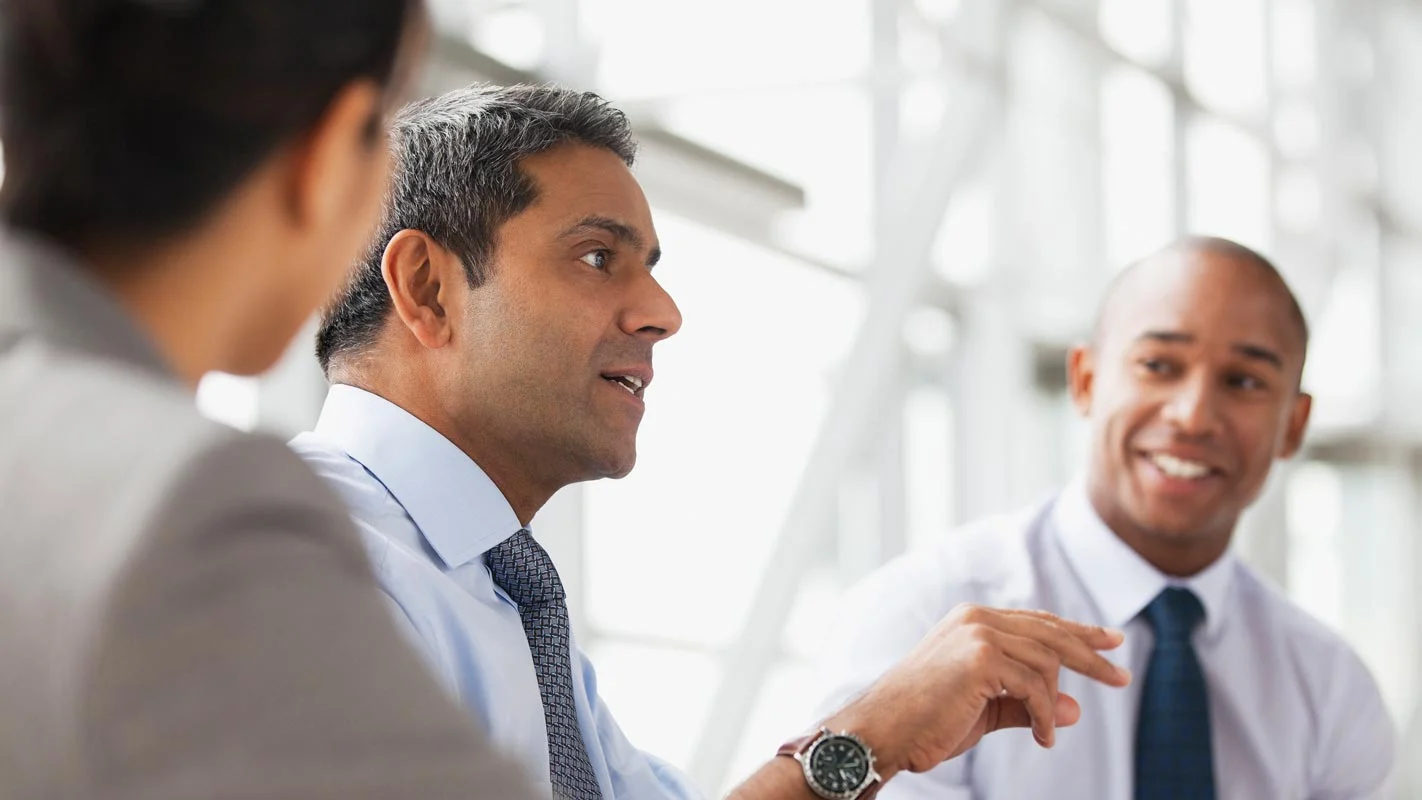 Group of business men in ties talking
