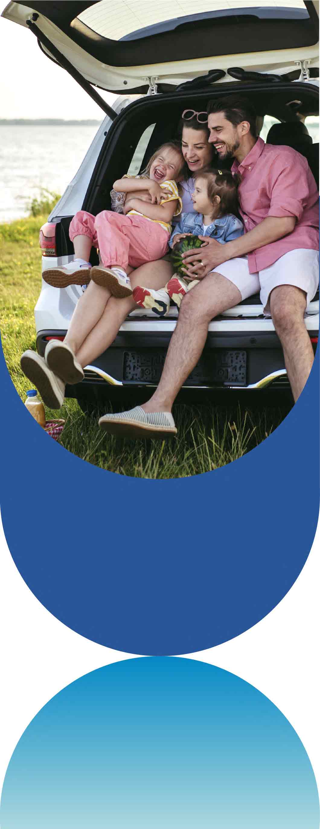 A family sits in the open trunk of a car by a lake, enjoying a picnic with watermelons.
