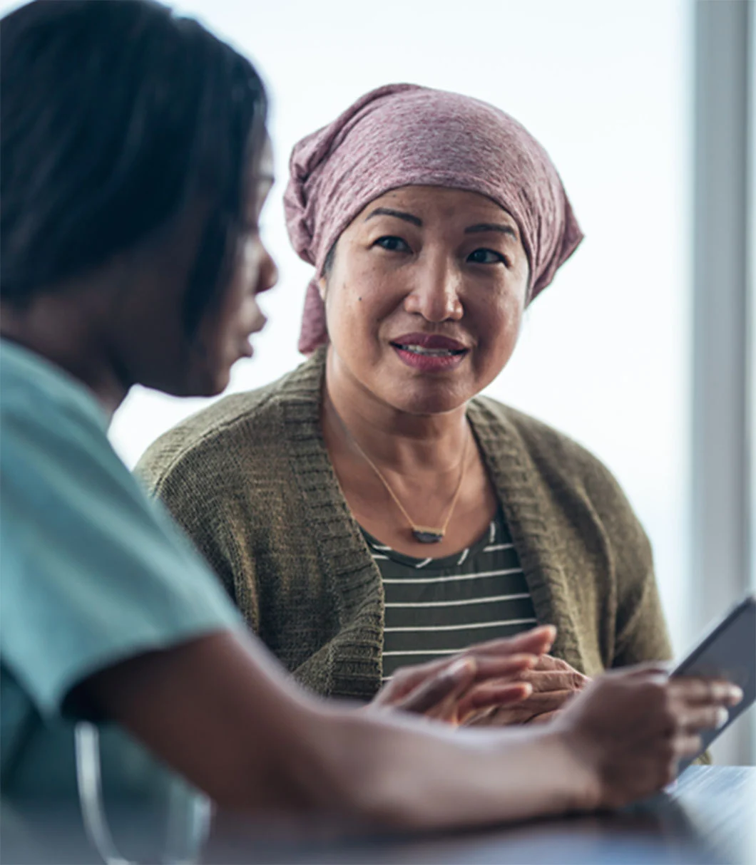 two women  reviewing information on a tablet