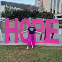Katelyn standing in front of a sign that says "hope."